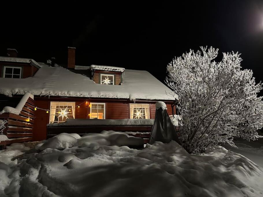 a house is covered in snow at night at 54:an - flott rekkehus med gangavstand til sentrum in Røros