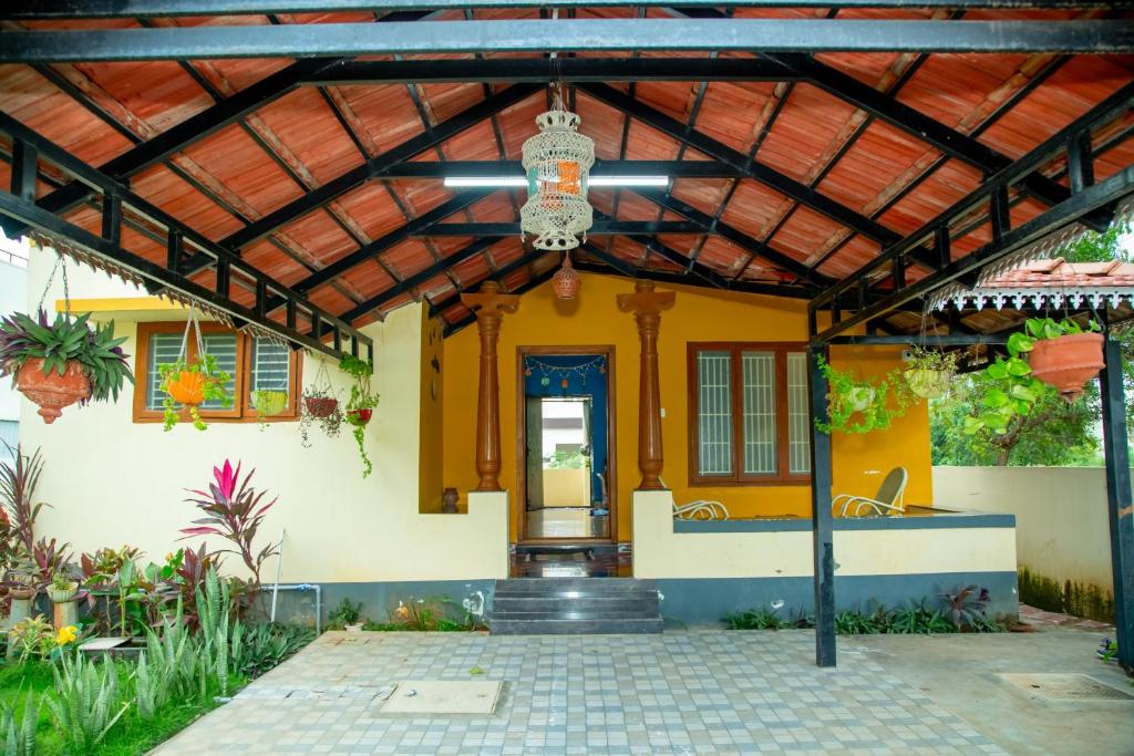 a yellow house with a wooden roof at A Chettinad villa in Coimbatore in Coimbatore