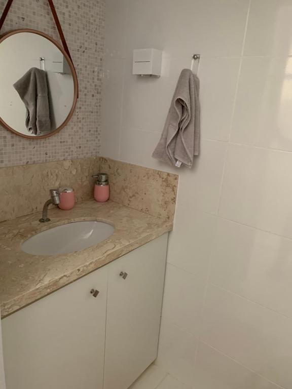 ein Bad mit einem Waschbecken und einem Spiegel in der Unterkunft Casinha da Paz in Aracaju