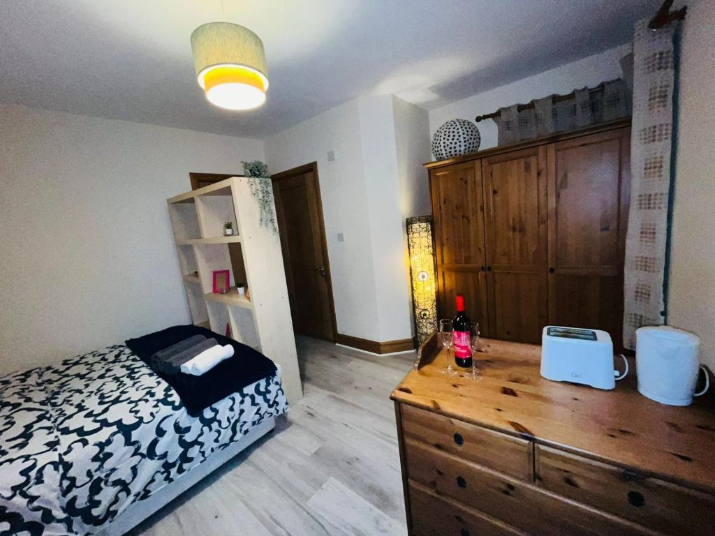 um quarto com uma cama e uma cómoda em madeira em Bedroom + Bathroom D8 em Dublin