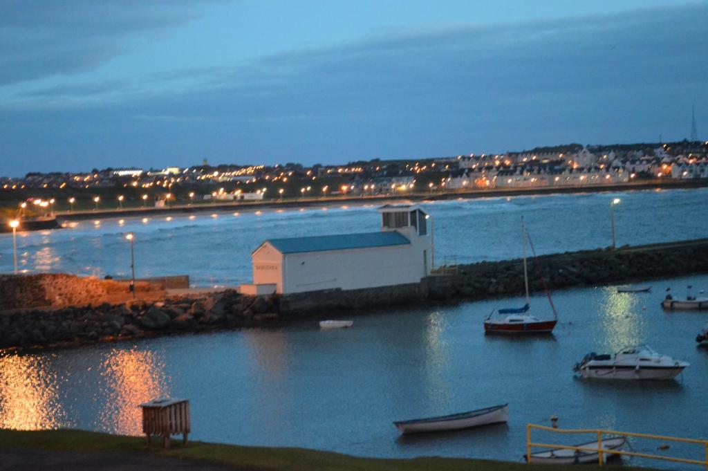 a harbor with boats in the water at night at Pier39Portrush Adult Only in Portrush
