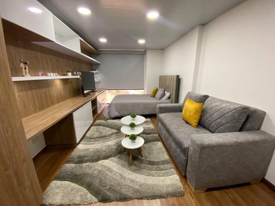 a living room with a couch and a table at Hermoso Loft en North Point in Bogotá