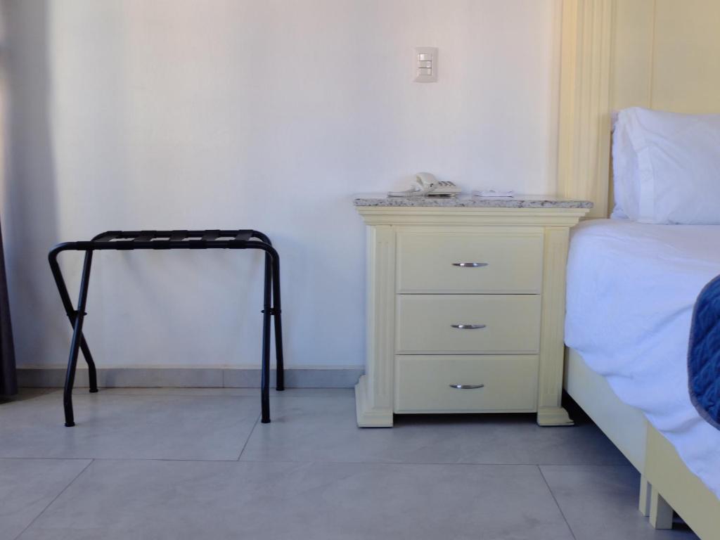 Postel nebo postele na pokoji v ubytování Hotel Estancia Real