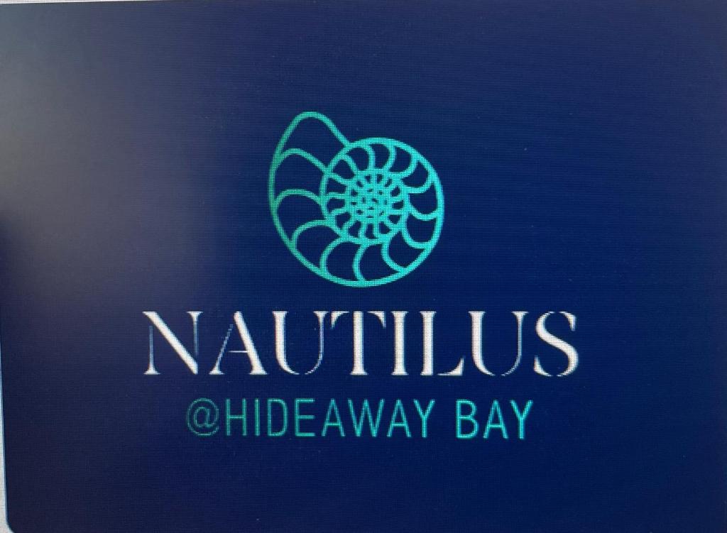a blue sign with a nautilus allergy laboratory logo at Nautilus @Hydeaway Bay/ Hideaway Bay in Hideaway Bay