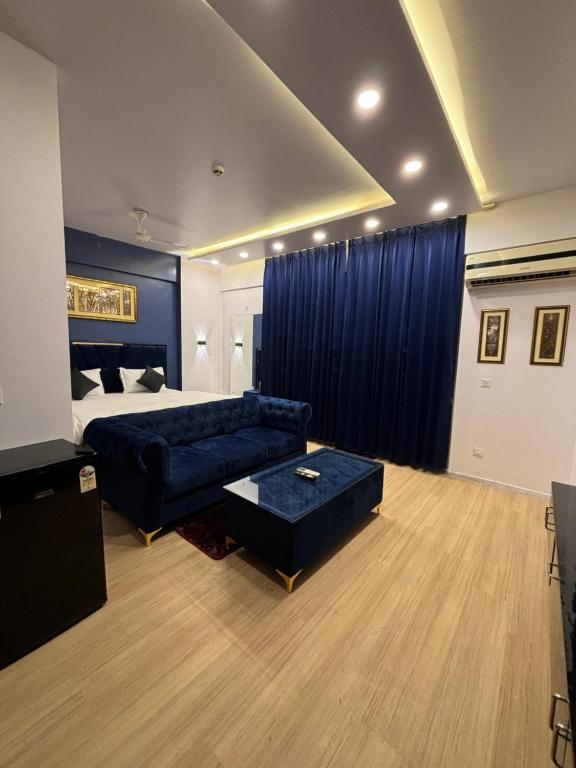 1 dormitorio con cama, sofá y mesa en The Royal Residency Suites,Lucknow Gomti Nagar, en Lucknow