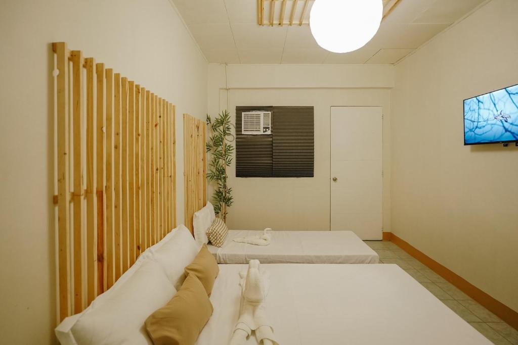 Postel nebo postele na pokoji v ubytování Pallet Homes - Megaworld