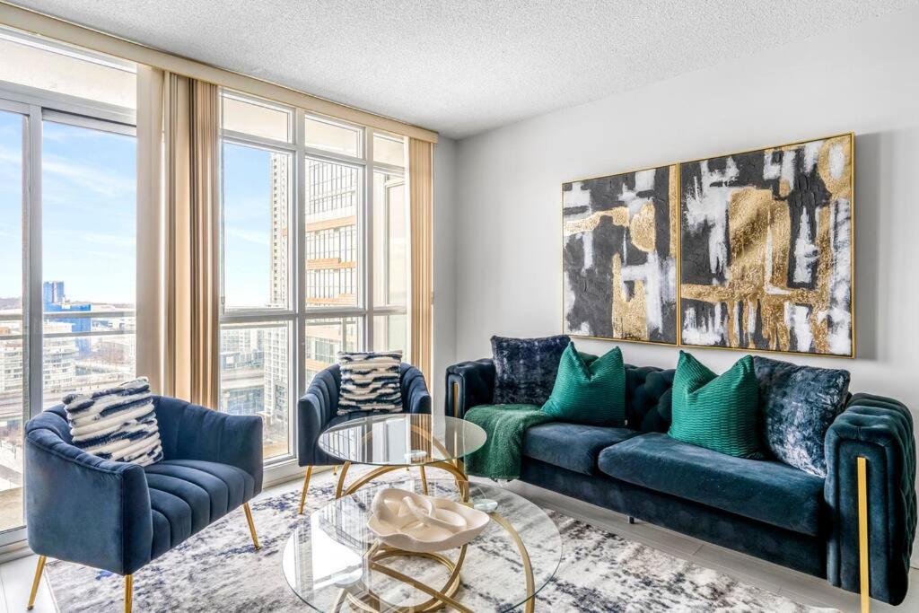 a living room with a couch and two chairs at One Bed and Den Upscale Comfort Condo with Parking in Toronto