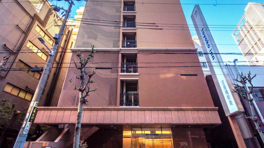 a building on a city street with at Toyoko Inn Osaka Yodoyabashi-eki Minami in Osaka