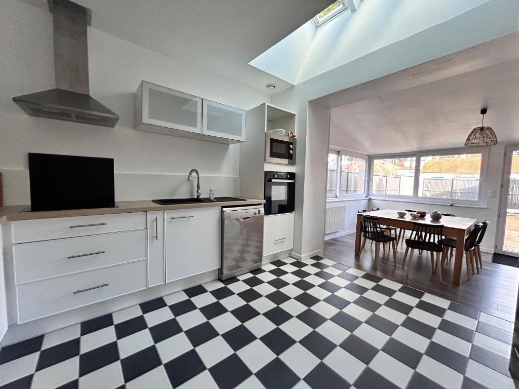 a kitchen with a black and white checkered floor at Maison rénovée 4 ch. avec jardin, à 700m de la plage et proches commerces - St Brevin Les Pins - FR-1-364-152 in Saint-Brevin-les-Pins
