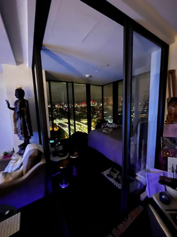 a bedroom with a view of a city at night at Luxurious Versace Apartment in London