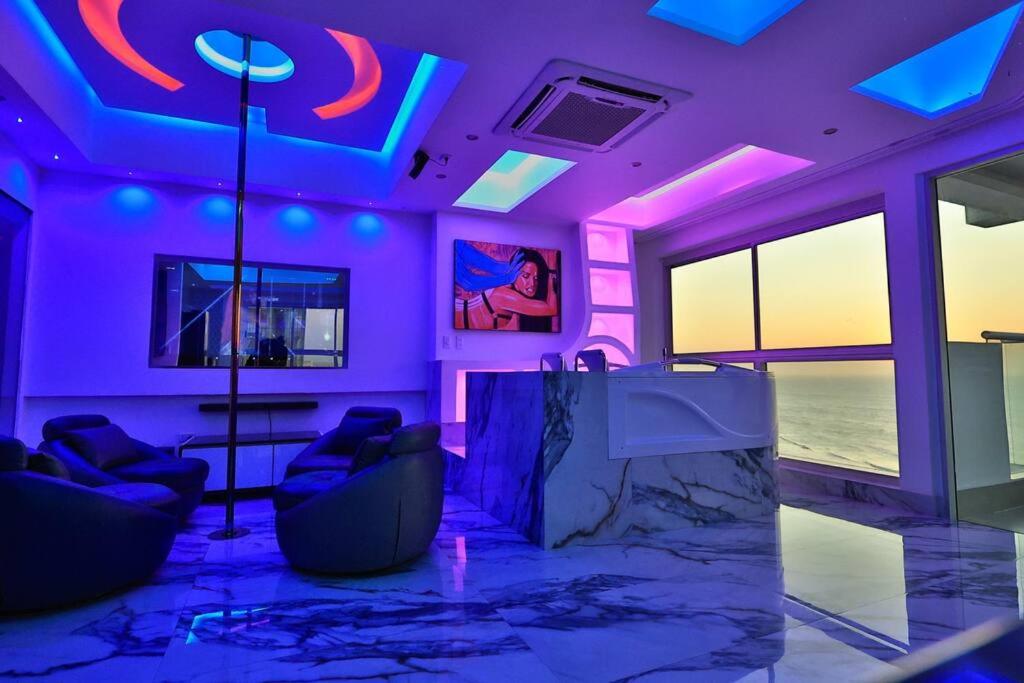 a room with purple and blue lights and chairs at Guest Friendly Cartagena 2BR Jacuzzi stripper pole in Cartagena de Indias