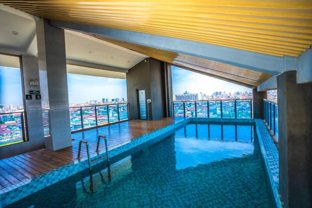 a large swimming pool with a view of the city at ARK House in Phnom Penh
