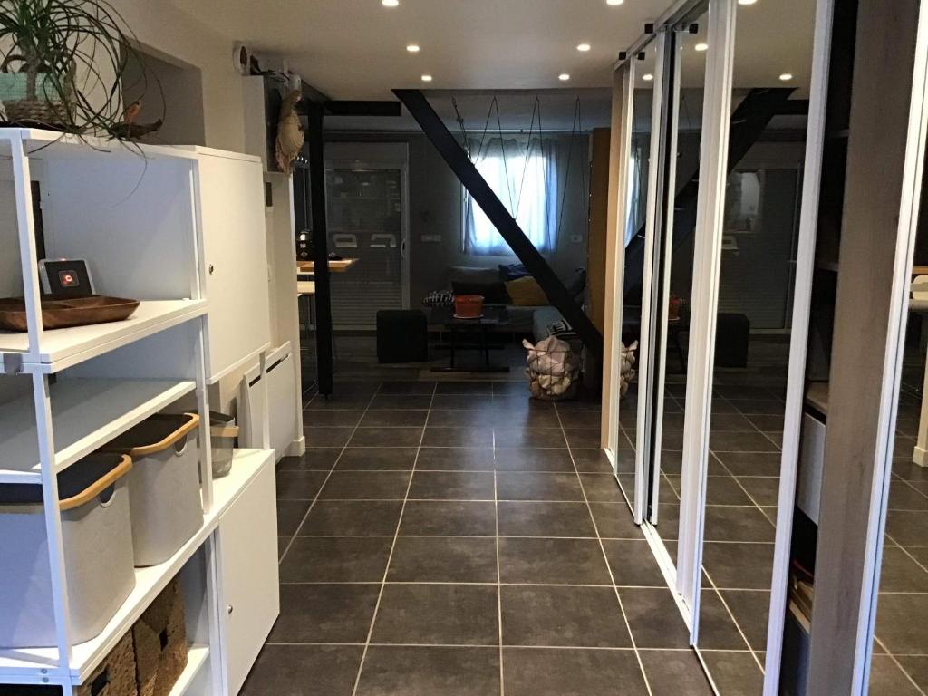 a room with a tiled floor and a hallway at Lepadaloft in Villeneuve-Saint-Georges