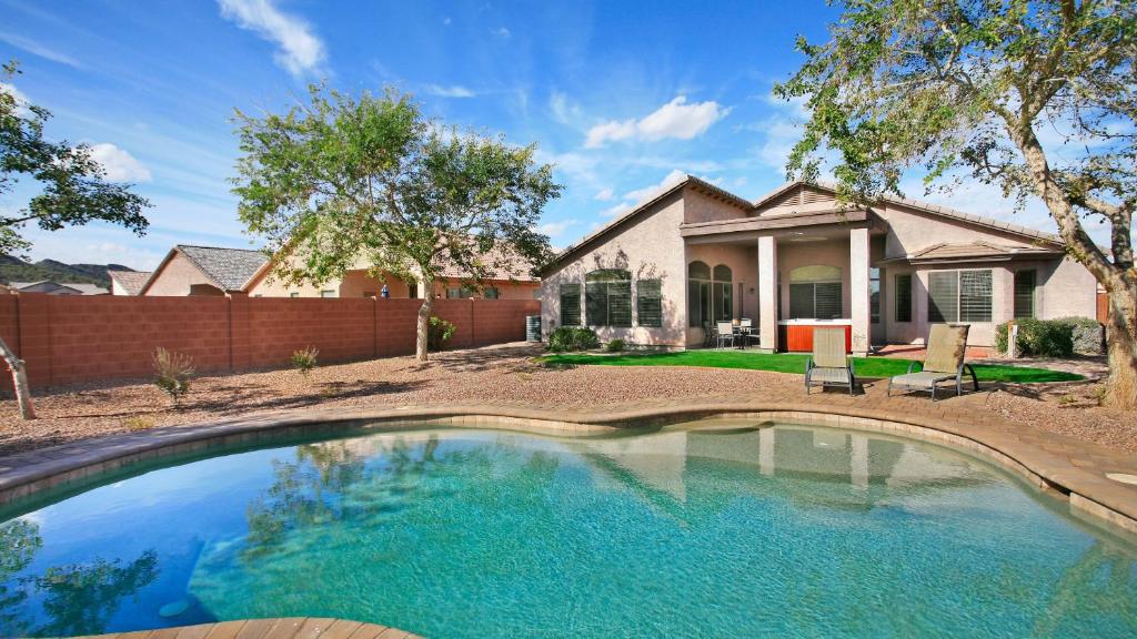 a house with a swimming pool in front of a house at Glendale Home in Phoenix