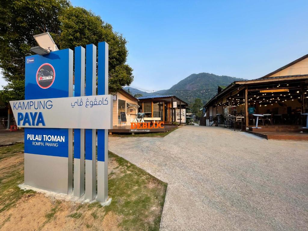 a sign in front of a building with a pavilion at Paya Debloc Village in Tioman Island