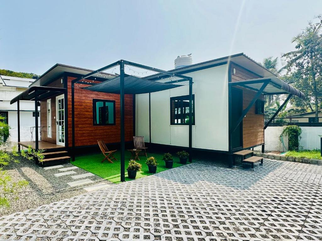 a small house with a pavilion on a cob at WHOOSH HOMES in Cochin