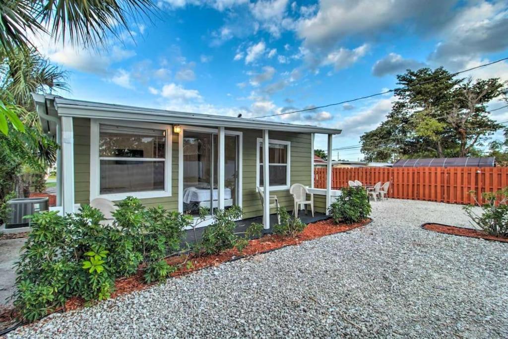 a tiny house with a patio and a fence at Palm Wave Stays - Central and Cozy Apt in West Palm Beach