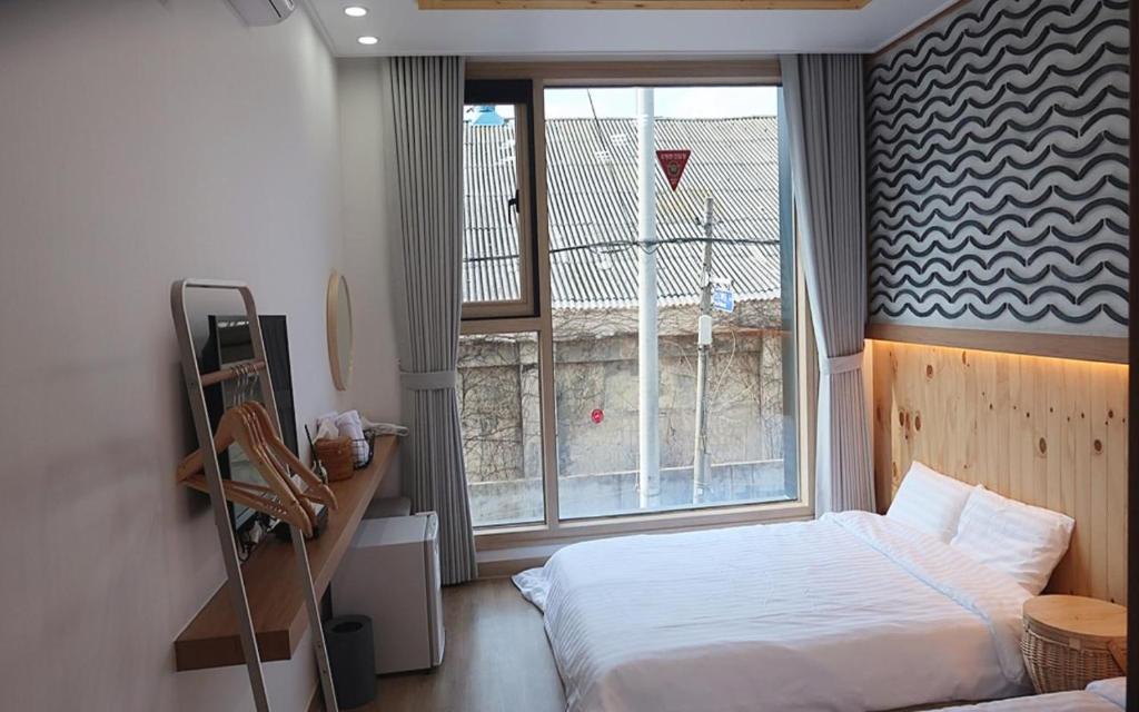 Postel nebo postele na pokoji v ubytování 38th Street Guesthouse