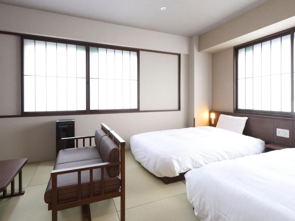Postel nebo postele na pokoji v ubytování Onyado Nono Asakusa Bettei Hot Spring