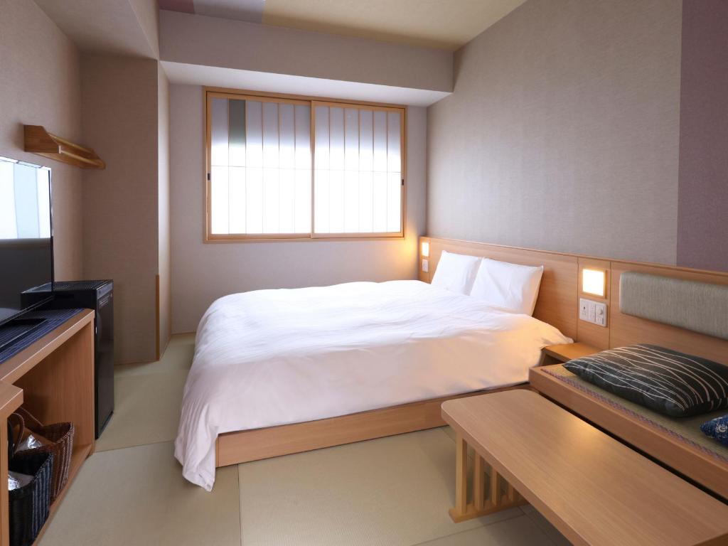 Postel nebo postele na pokoji v ubytování Onyado Nono Asakusa Bettei Hot Spring