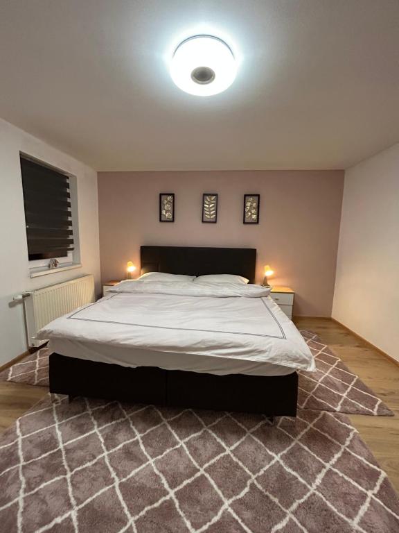 a bedroom with a large bed with two lights on it at Schönes Haus in Sankt Pölten