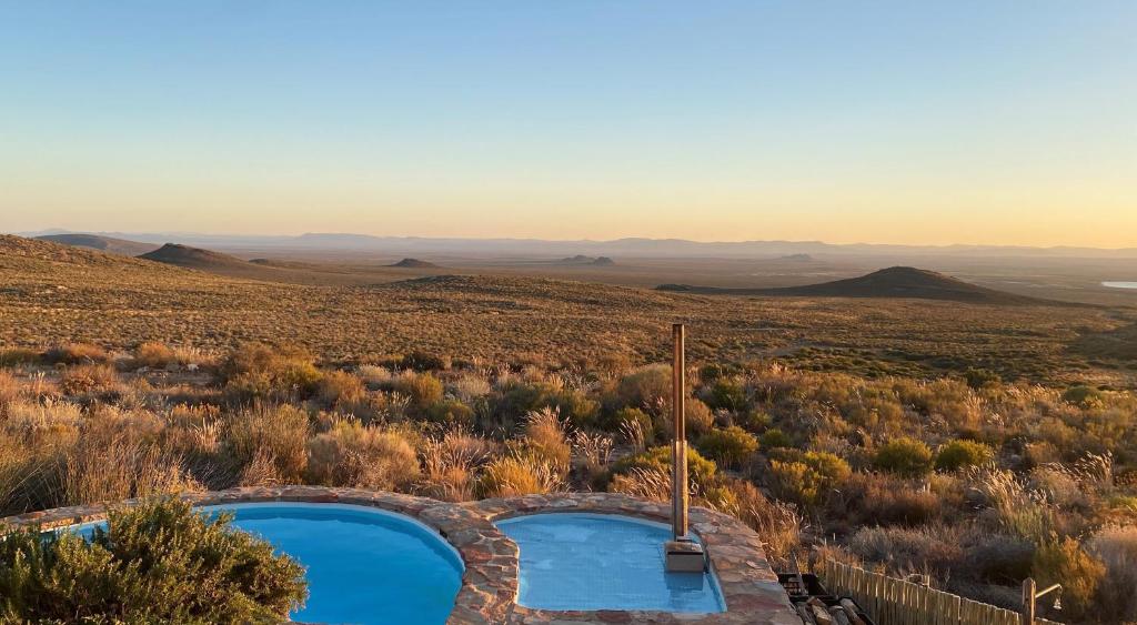 an overhead view of a swimming pool in the desert at Tierkloof Mountain Cottages in Breede River DC
