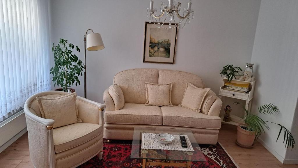 a living room with a couch and a chair at Ferienwohnung Adelsberg in Alpirsbach