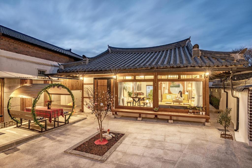 an asian style house with a pavilion in a courtyard at And spring in Jeonju