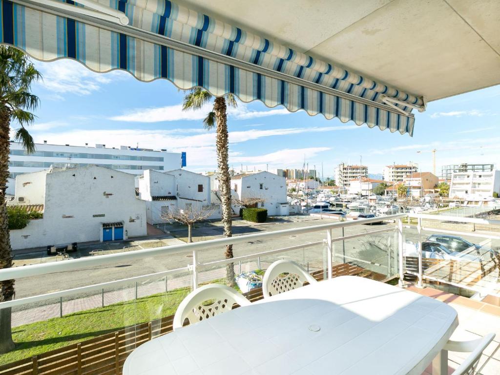 a table and chairs on a balcony with a view of a city at Apartamento Roses, 2 dormitorios, 5 personas - ES-228-119 in Roses