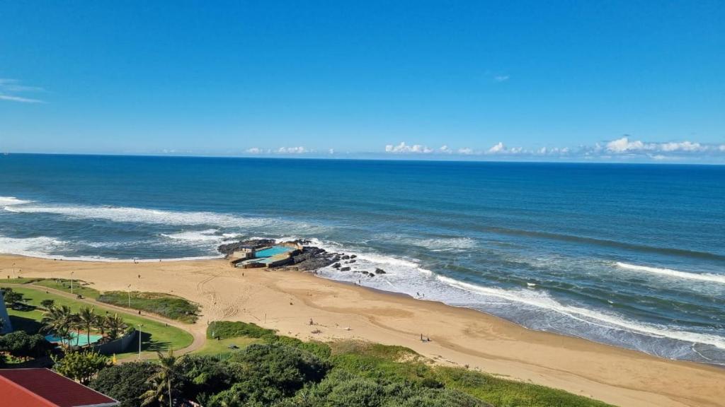 an aerial view of a beach and the ocean at 146 Stella Maris Durban Amanzimtoti in Amanzimtoti