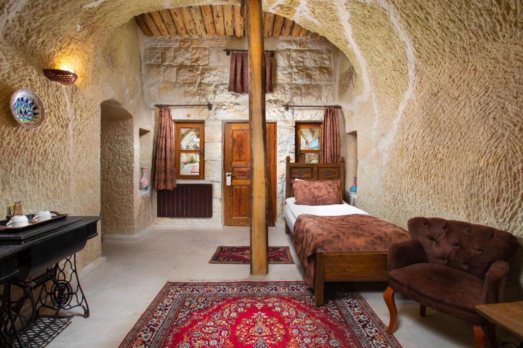 A bed or beds in a room at Romantic Cave Hotel