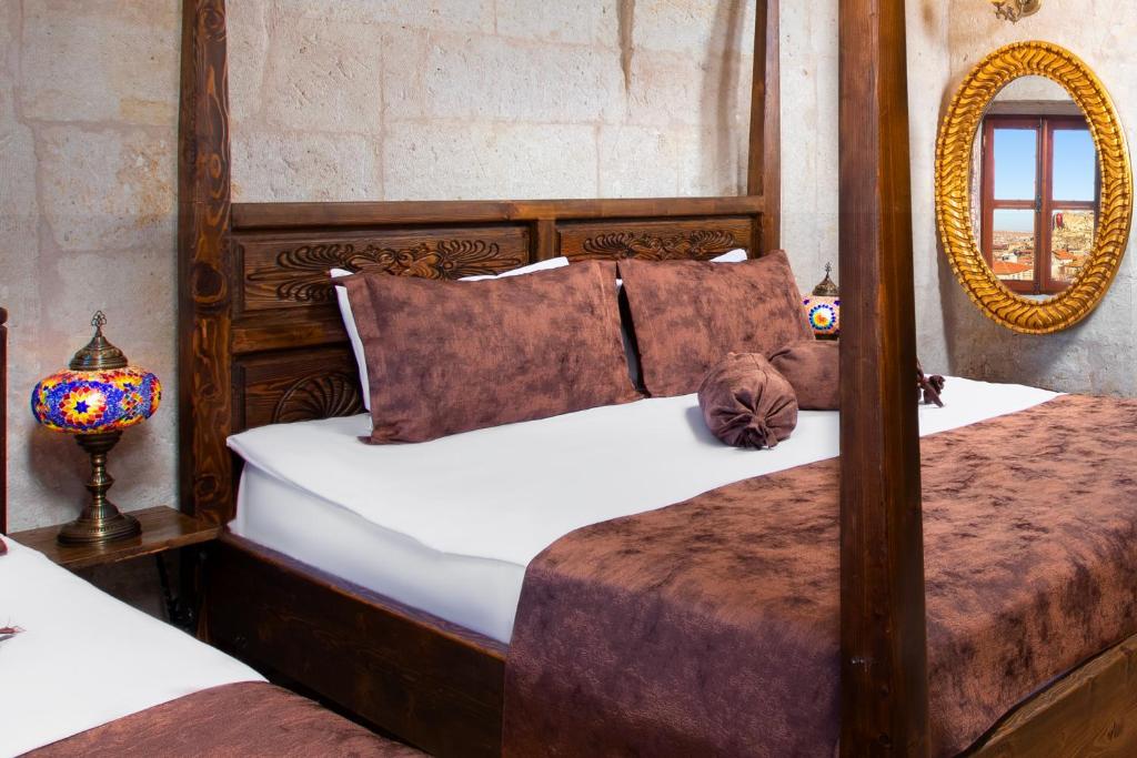 A bed or beds in a room at Romantic Cave Hotel