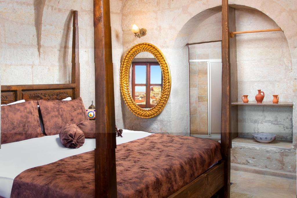A bed or beds in a room at Romantic Cave Hotel