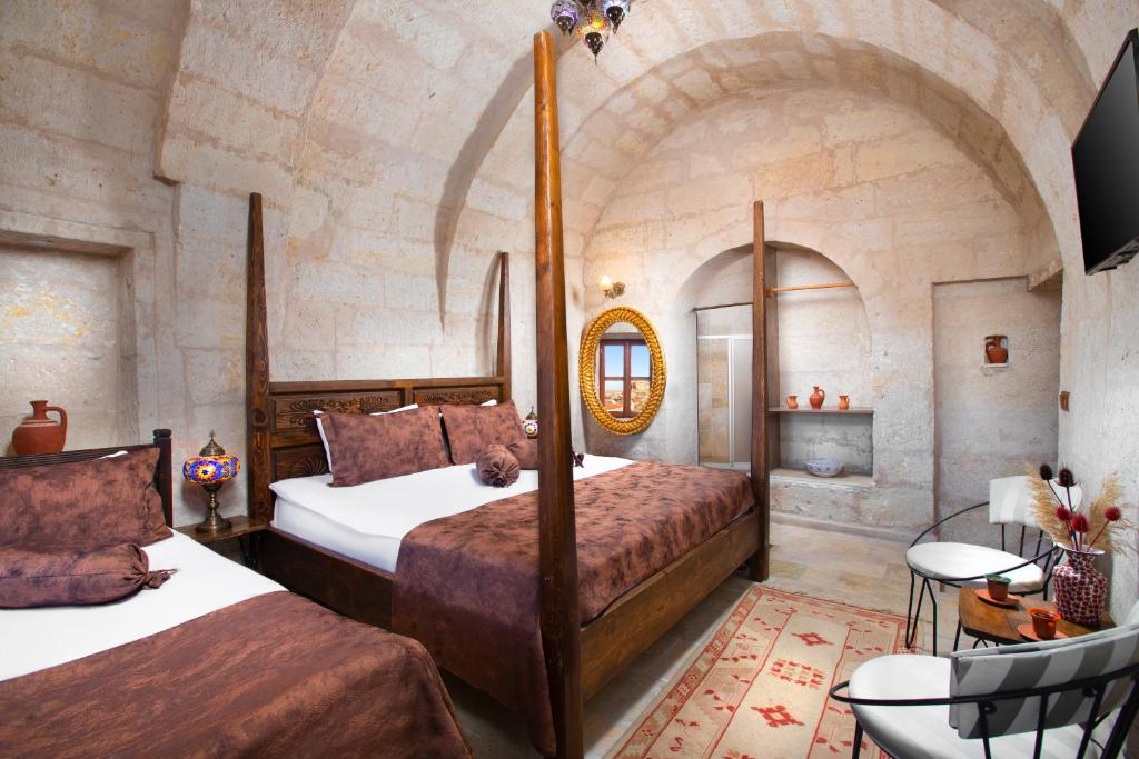 A bed or beds in a room at Romantic Cave Hotel