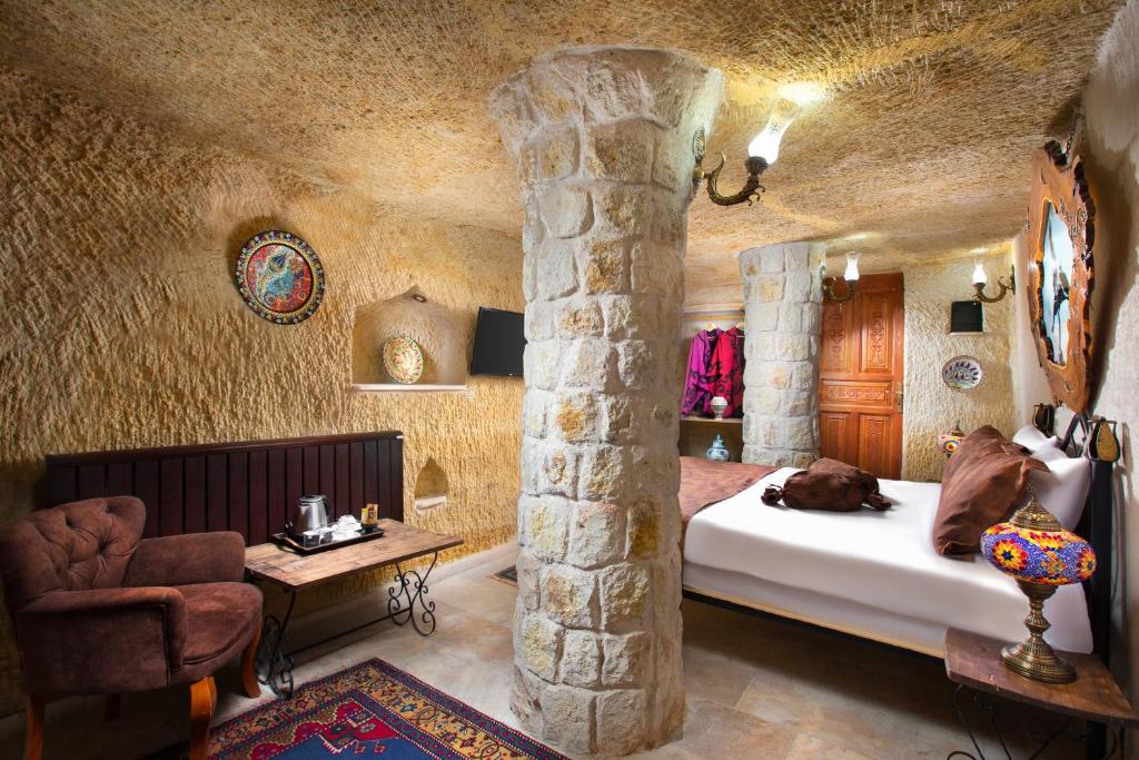 A bed or beds in a room at Romantic Cave Hotel