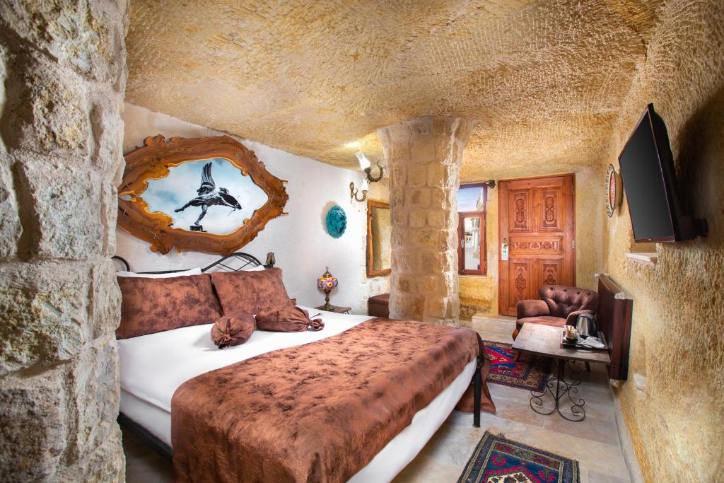 A bed or beds in a room at Romantic Cave Hotel
