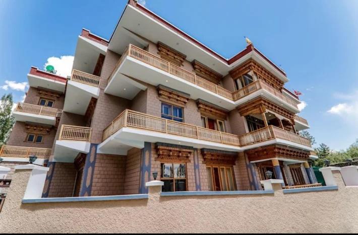 a large building with balconies on the side of it at Sankar Residency in Leh