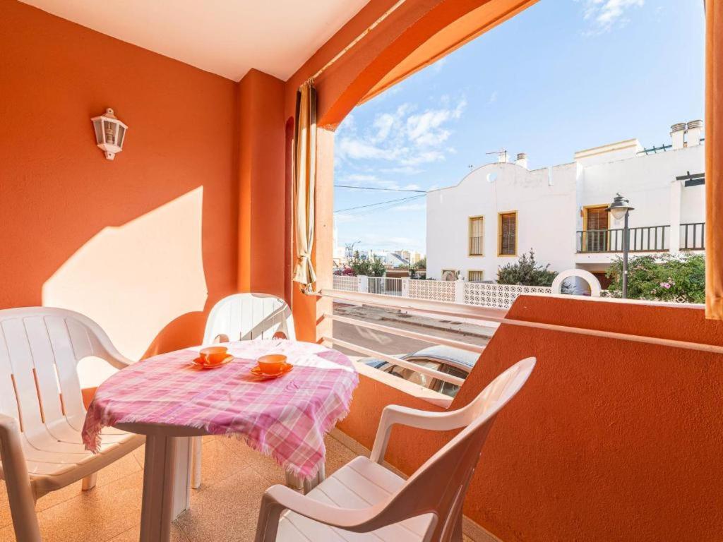 a balcony with a table and chairs and a window at CABO DE LAS ÁGATAS in El Cabo de Gata