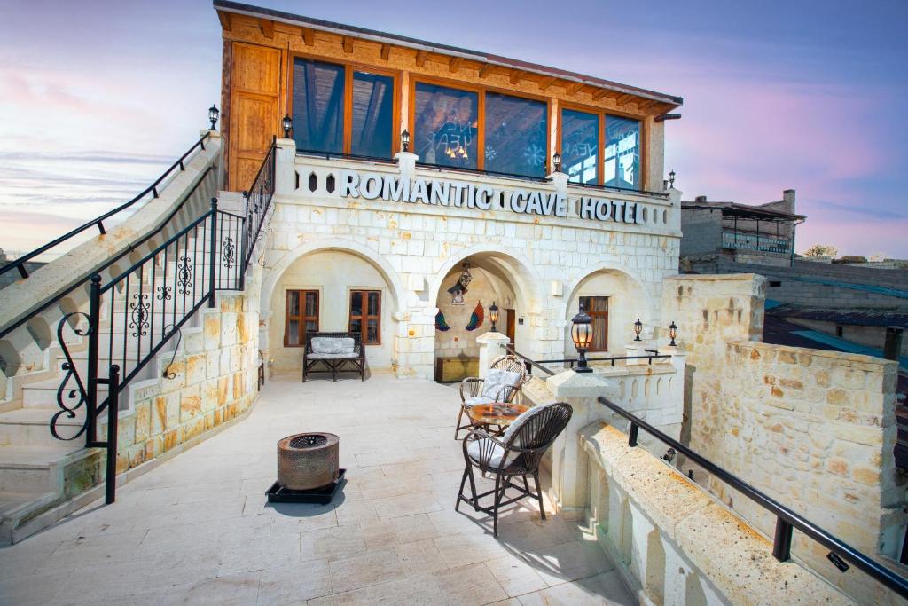 a building with a sign on the side of it at Romantic Cave Hotel in Nevsehir