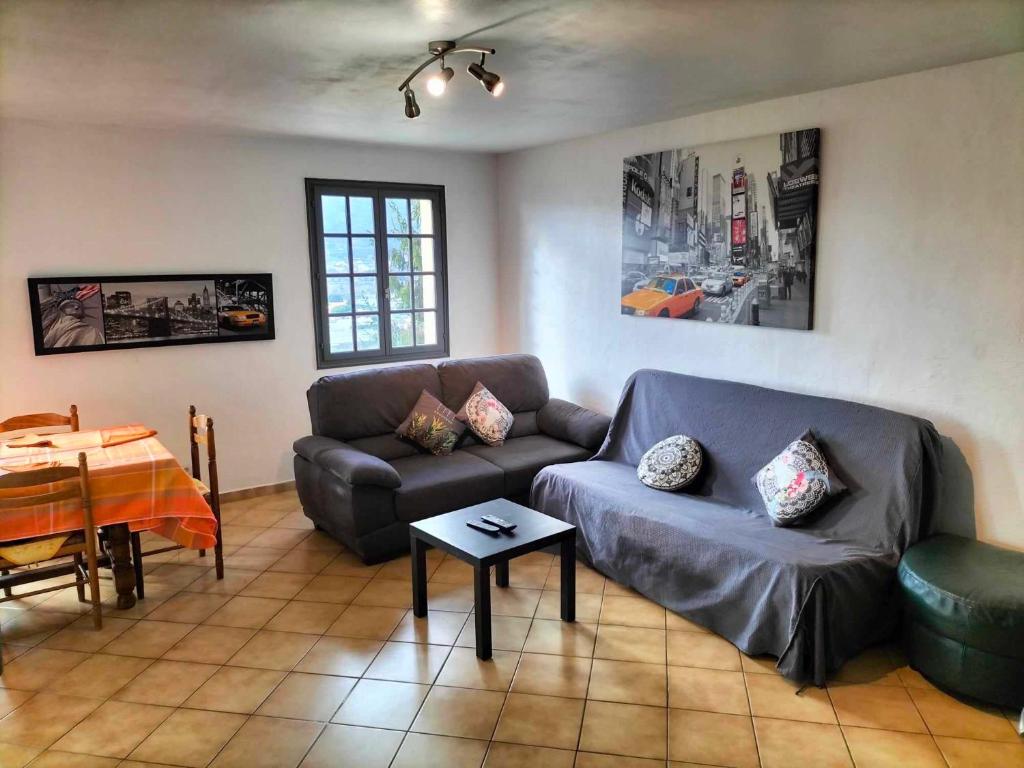 a living room with a couch and a table at Appartement dans villa Niçoise in Nice