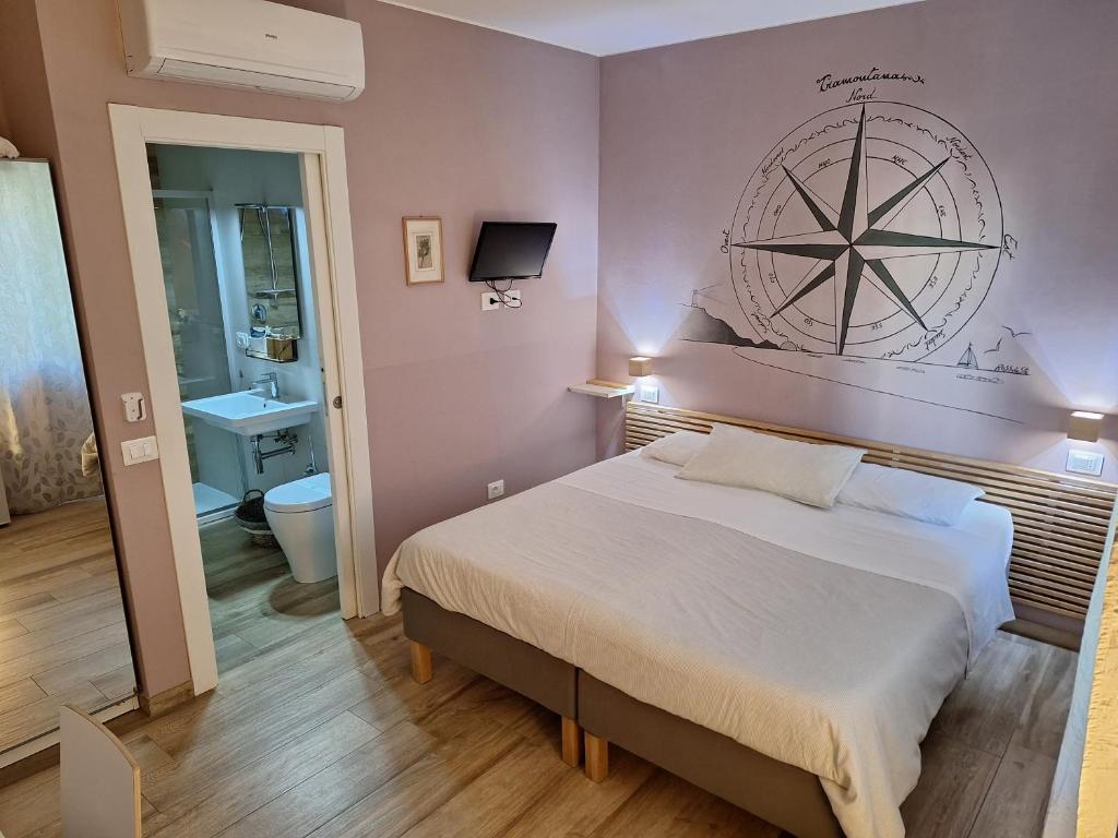 a bedroom with a large bed and a bathroom at Sweet Harbour B&B in Pesaro
