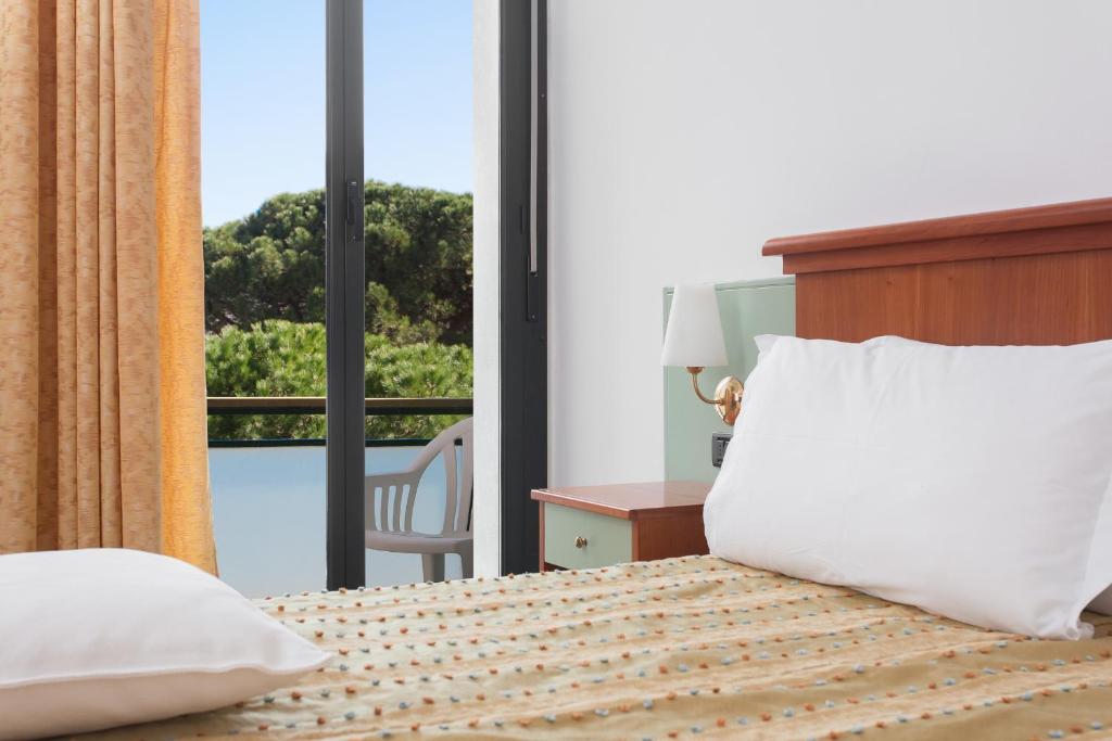 Postel nebo postele na pokoji v ubytování Hotel Zeus