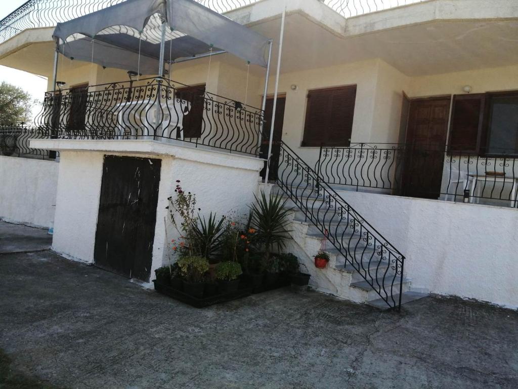 a house with a staircase and a balcony at Cozy Rodas House 1 in Skála