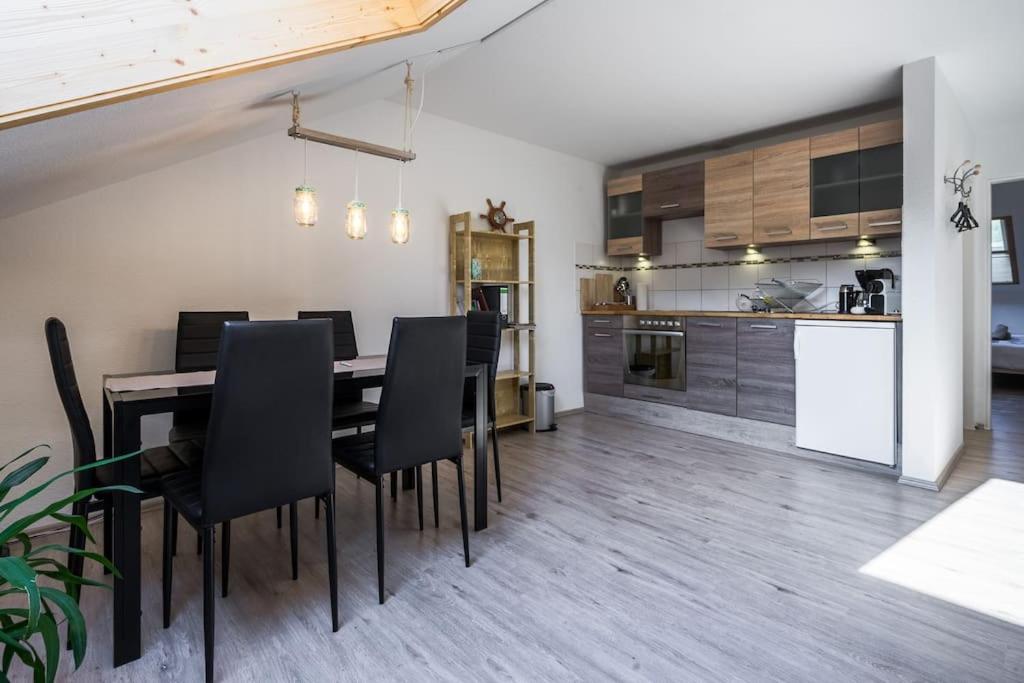a kitchen and dining room with a table and chairs at Newly renovated apartment in Bernau im Schwarzwald