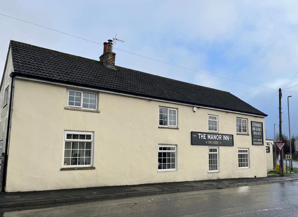 a white building with a sign that reads the maxmill at The Manor Inn Pub and Steakhouse, Fridaythorpe, Driffield in York