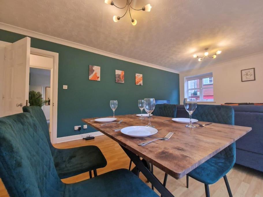 a dining room with a wooden table and blue chairs at Free Parking: Perfect City Centre Flat in Manchester