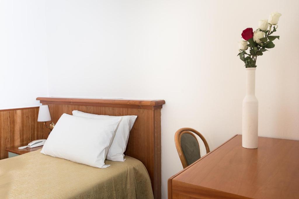 Postel nebo postele na pokoji v ubytování Hotel Zeus