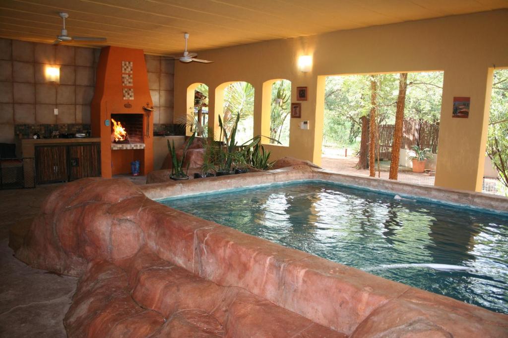 a large swimming pool in a house with a swimming pool at Kiburi Lodge @ Kruger, a secluded Bushveld getaway in Marloth Park