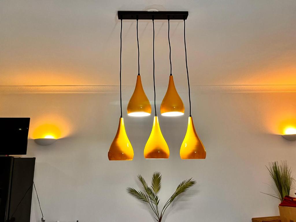 a group of lights hanging from a wall at Beachaven (7 Bedroom/5 Bathroom) in Weymouth