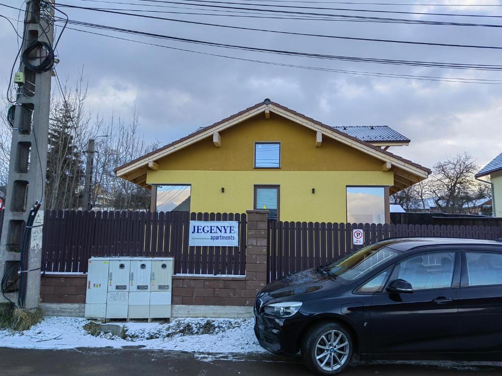 a car parked in front of a house at Jegenye apartments in Miercurea-Ciuc